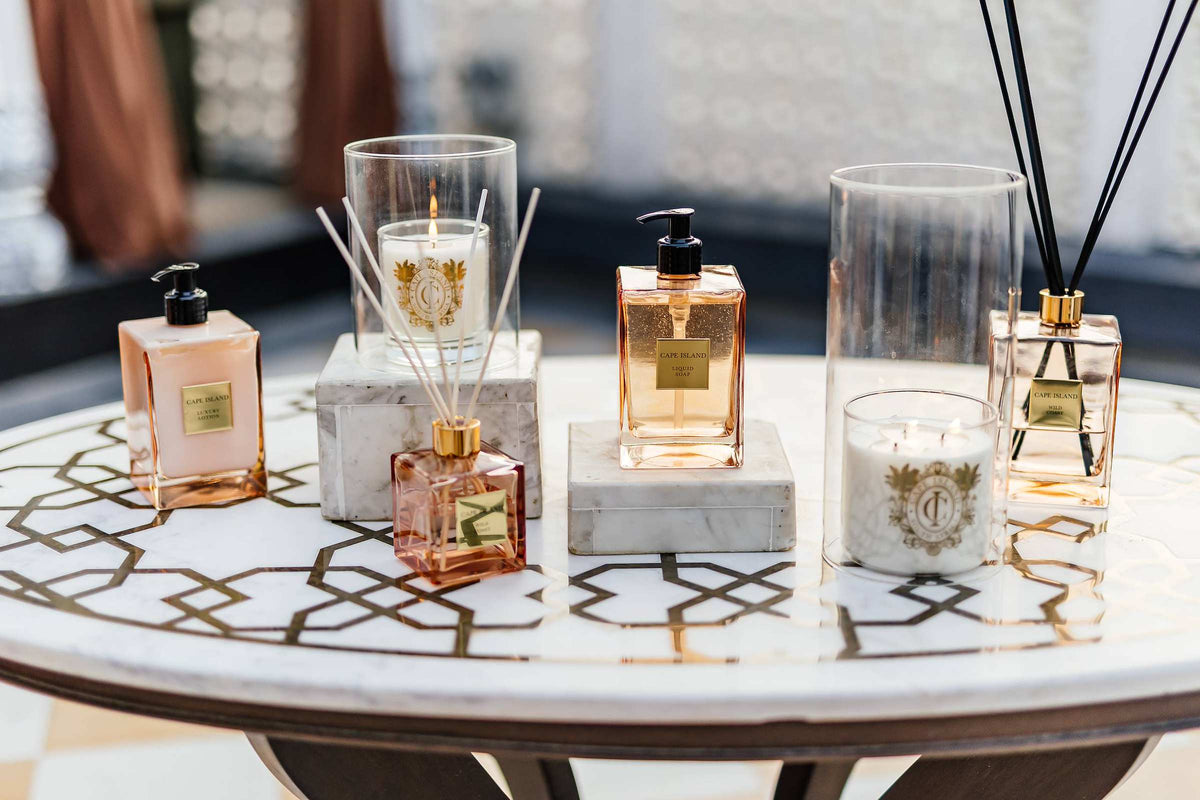 Candles, diffusers and body care on an inlaid marble table